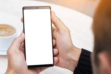 Close up of man's hands holding mobile smart phone.