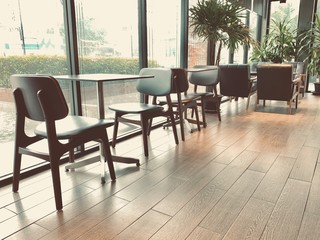 table and chairs in cafe, interior of restaurant cafe with window glass and table with chair against brown color of floor tile