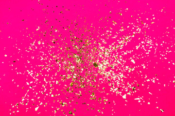 Golden flying sparkles on Plastic pink neon background. Festive backdrop for your projects. - 290004768