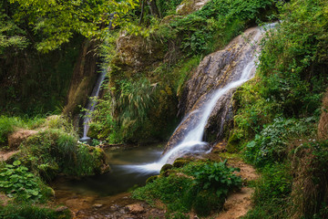 Fototapeta na wymiar Waterfall in Gostilje village, close up of cascades. Nature outdoors travel destination Gostilje, Zlatibor mountain, Serbia 