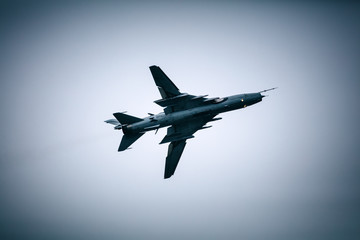 Fototapeta na wymiar Military jet fighter flying in the cloudy sky
