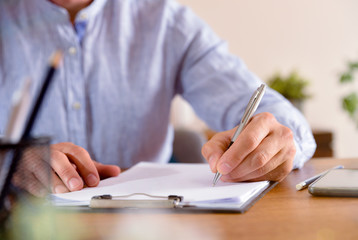 Man starting to write on empty sheet front view