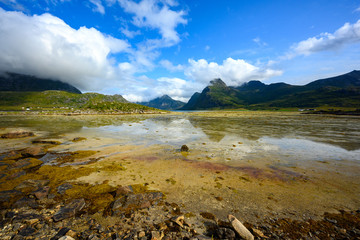 Puddles and mountains during the summer. Blue sky at lofoten island, Norway