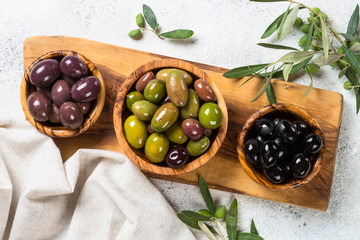 Black and green olives on white background.