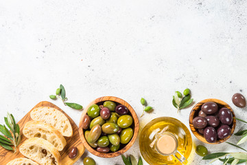 Olives, ciabatta and olive oil on white background. - obrazy, fototapety, plakaty
