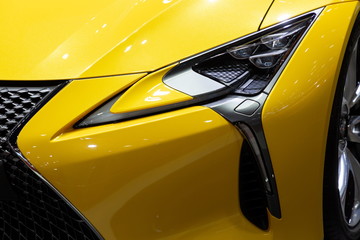 close up front view headlight yellow color car 