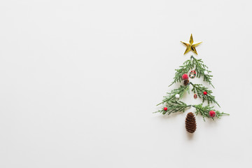 Christmas tree made of christmas decorations over white background and copy space. flatlay