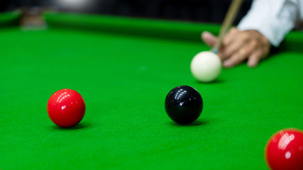 Game snooker billiards or opening frame player ready for the ball shot, athlete man kick cue on the green table in bar.