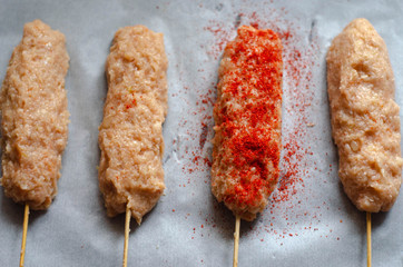 Raw kebab with spices on a table ready to cook