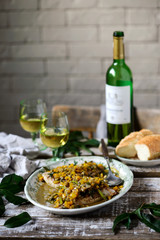Fish under a vegetable marinade with wine.