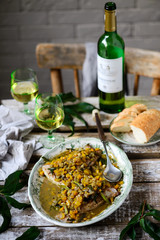 Fish under a vegetable marinade with wine.