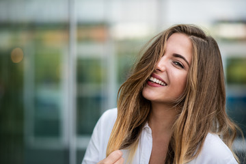 Smiling fashion model posing outdoors