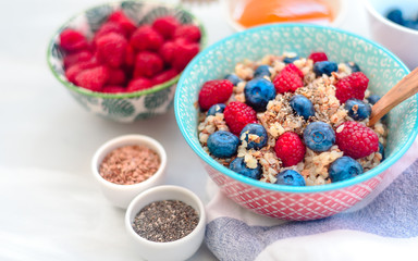 breakfast buckwheat porridge with raspberries and blueberries, good morning concept