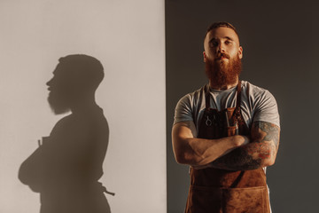 Confident hairdresser with crossed arms