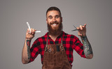 Cheerful barber with professional tools