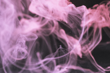 Fototapeta premium Defocused violet smoke on black screen