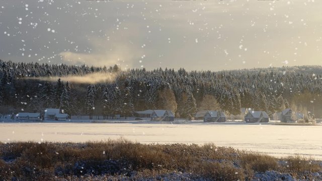 winter rural landscape with village houses under snow and snowfall