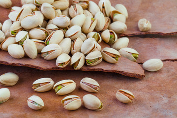 Tasty pistachio nuts on tree rind background