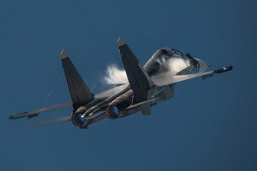 Military jet fighter with The Prandtl–Glauert singularity effect  - obrazy, fototapety, plakaty