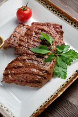 Steak on the bone with red sauce. restaurant menu