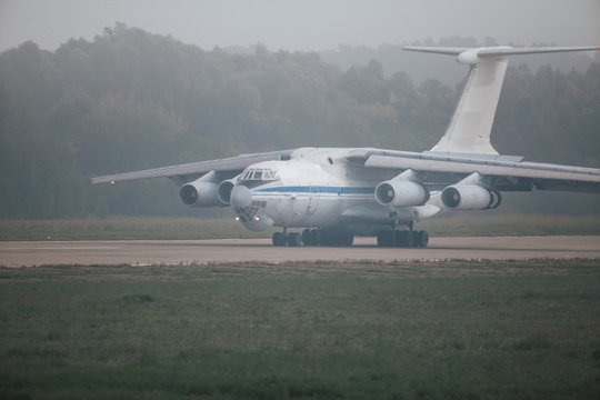 Heavy cargo airplane on the runway at fog