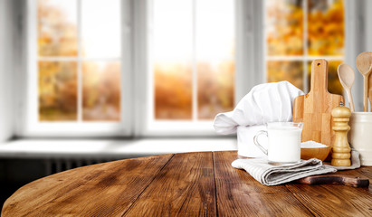 Wooden table of free space for your decorationa and white wooden window space with autumn landscape 