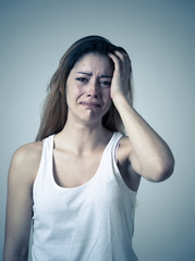 Young attractive woman sad and depressed feeling desperate. Human expressions and emotions