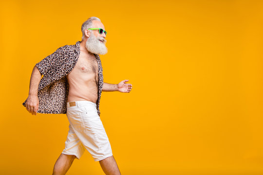 Copyspace photo of old man moving torward something during holiday abroad while isolated with yellow background