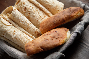 Pita bread of different types in a bread basket . restaurant menu