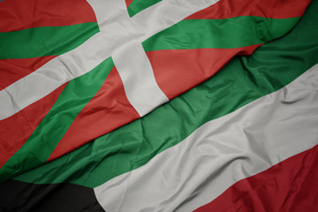 Obraz premium waving colorful flag of kuwait and national flag of basque country.