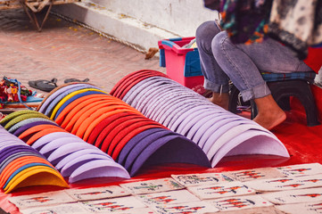 Street  market vendor in the famous Luang Prabang Night Market in Laos selling handcrafted souvenirs to tourist