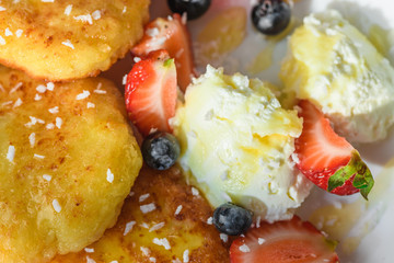 cheesecakes with honey tea and berries on a wooden table