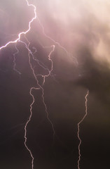 Fototapeta na wymiar Lightning strike in thunderstorm at the end of summer