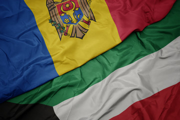 waving colorful flag of kuwait and national flag of moldova.