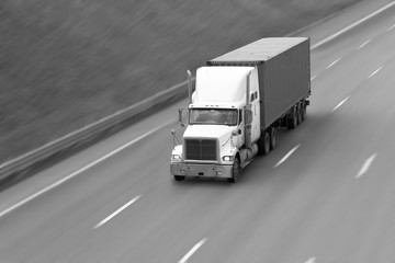 the truck goes on the highway in summer day