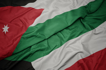 waving colorful flag of kuwait and national flag of jordan.