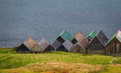 Fototapeta na wymiar House roofs near ocean in Faroe Islands