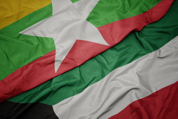 waving colorful flag of kuwait and national flag of myanmar.