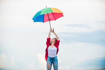 Rainbow umbrella. Rainy weather. Good mood. Good vibes. Parachute concept. Open minded person. Girl feeling good sky background. Good weather. Welcoming fall. Pretty woman with colorful umbrella