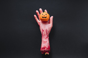 Chopped off plastic arm with toy pumpkin