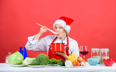 Try main meal. Easy ideas for christmas party. Healthy christmas holiday recipes. Woman chef santa hat cooking hold wooden spoons. Best christmas recipes. Christmas dinner idea. Festive menu concept