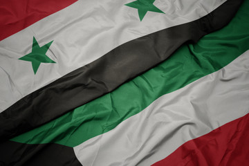 Obraz premium waving colorful flag of kuwait and national flag of syria.