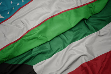 waving colorful flag of kuwait and national flag of uzbekistan.