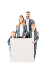 full length view of happy family smiling and holding blank placard isolated on white