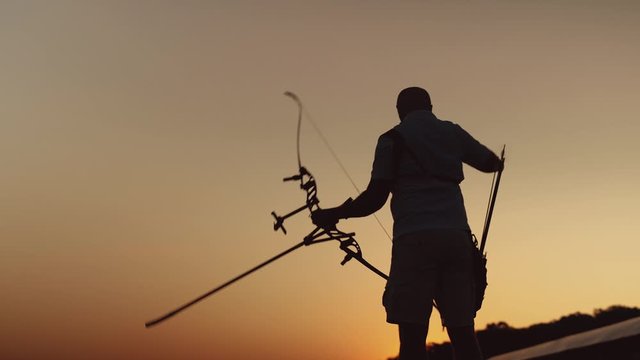 Archery silhouette. Man shoots a bow