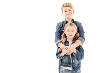 happy kids embracing and looking at camera isolated on white