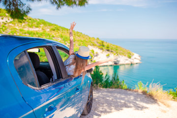 Little girl on vacation travel by car background beautiful landscape