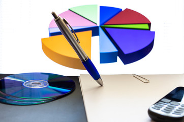 business graphs and charts with pen and disks