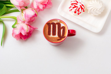 A cup of cappuccino coffee with a zodiac sign Virgo symbol