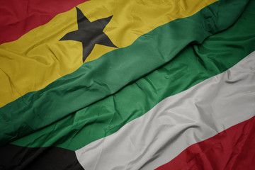 Obraz premium waving colorful flag of kuwait and national flag of ghana.